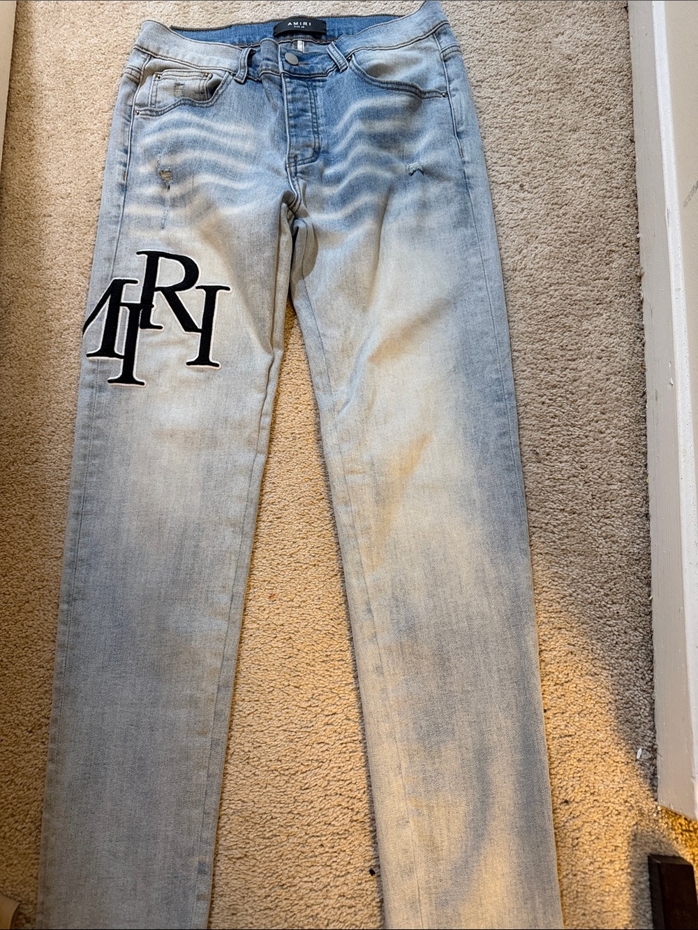 AMIRI Light Blue Slim Straight Jeans with Black Logo Patch